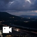 a city night view with river and mountain