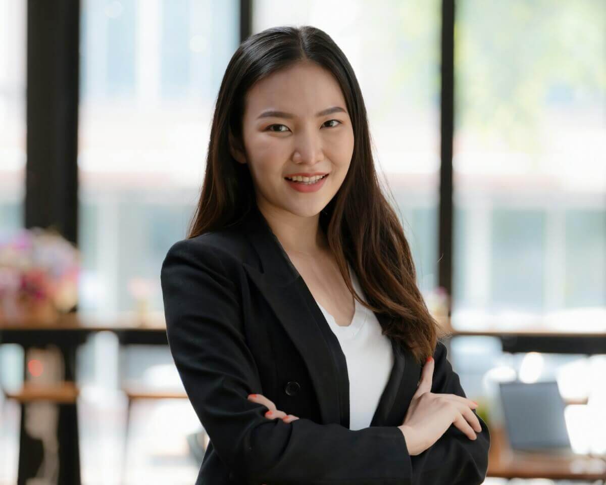 a woman in professional suits smiles into the camera