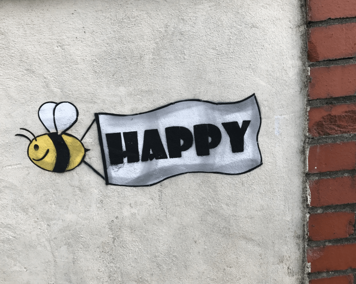 drawing about bee and flowing banner on the wall